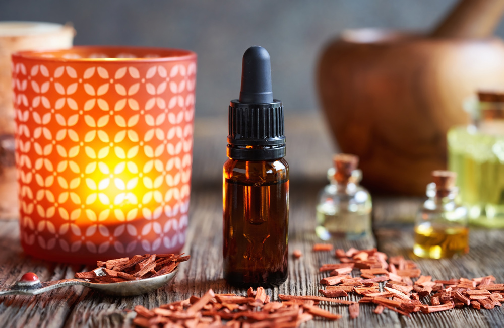 Essential oil bottle with pieces of red sandalwood