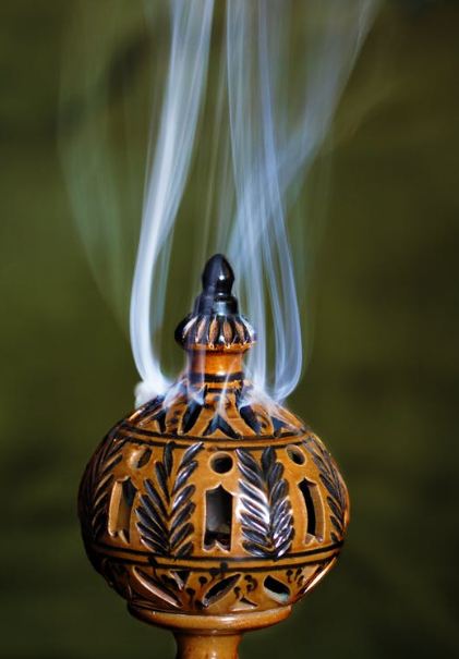 a closed pot emitting the aroma of incense