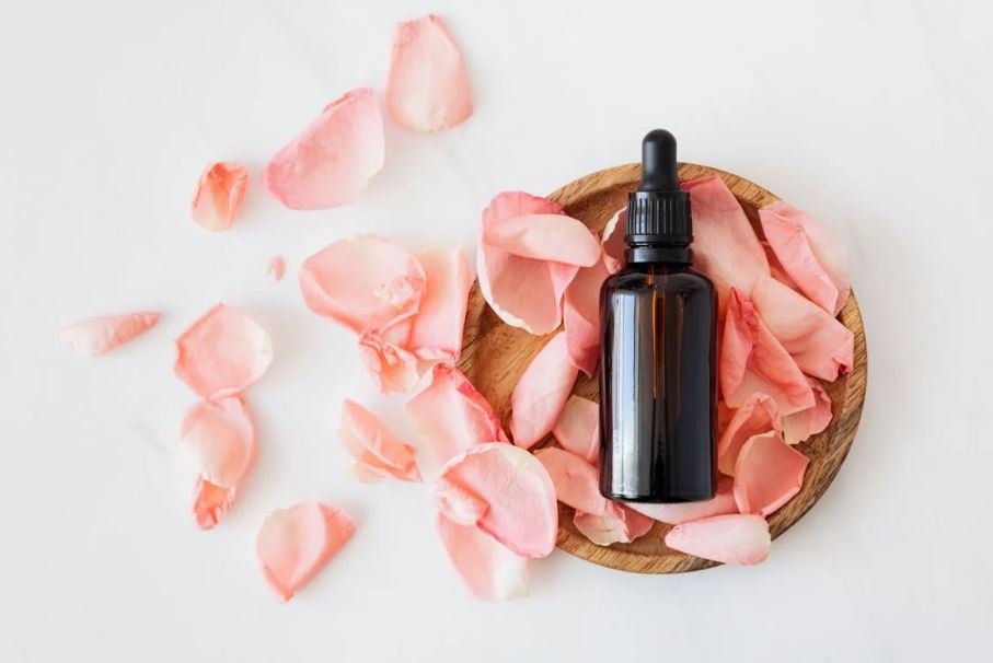 an oil bottle, rose petals