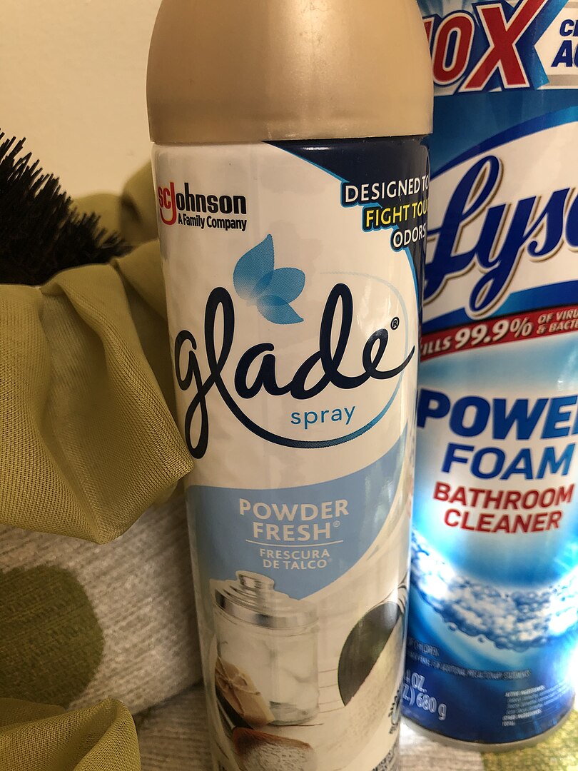 A can of Glade air freshener next to Lysol cleaner