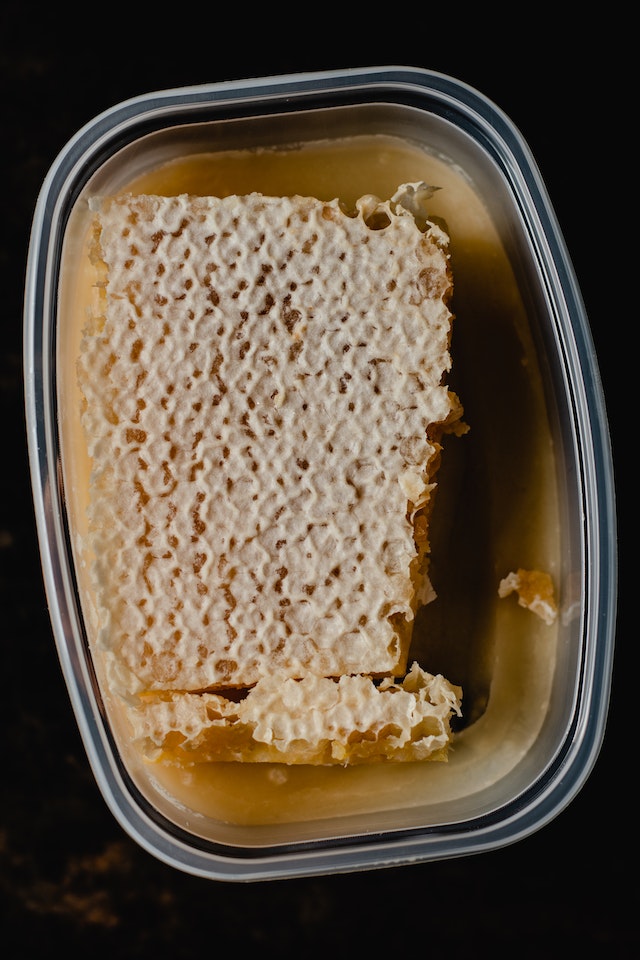 a plastic container with a cube of beeswax