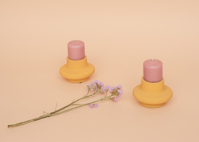 pink candles on yellow candle holders