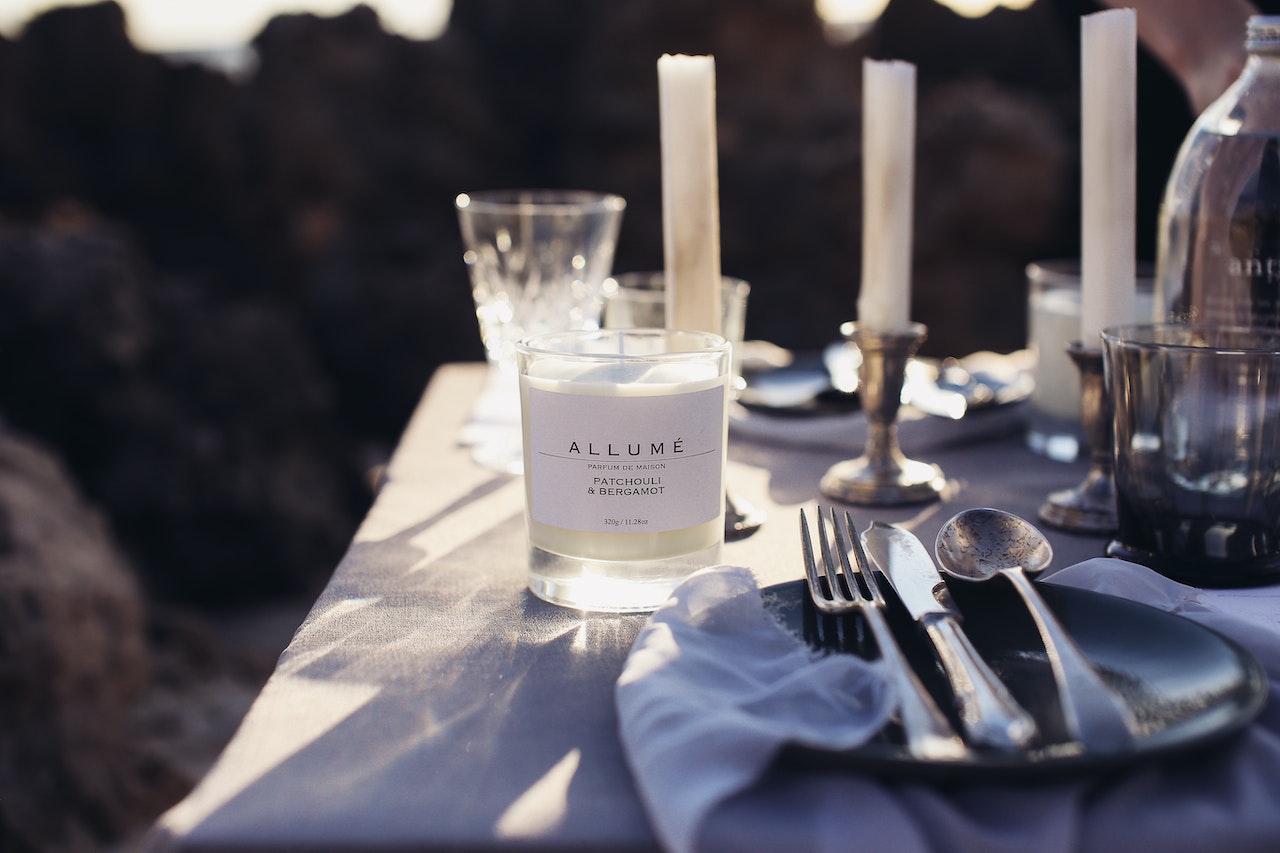 table setting with white scented candle