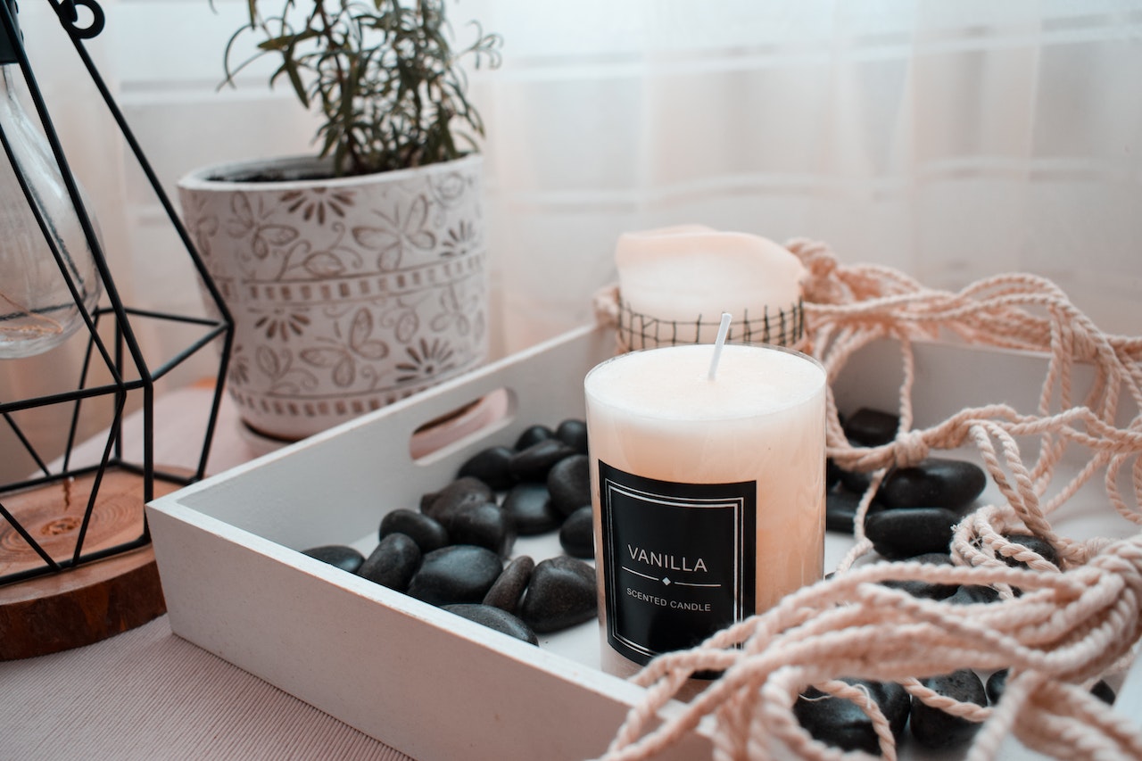 vanilla scented candle on a wooden tray