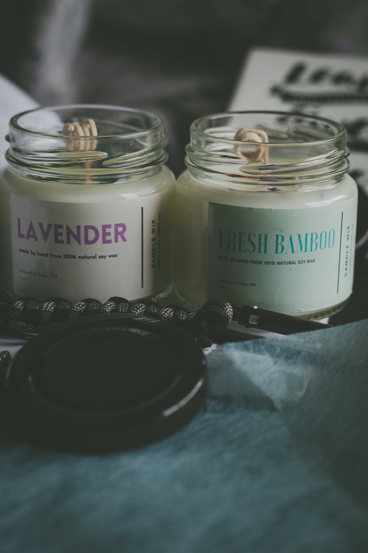 white scented candles on glass bottles
